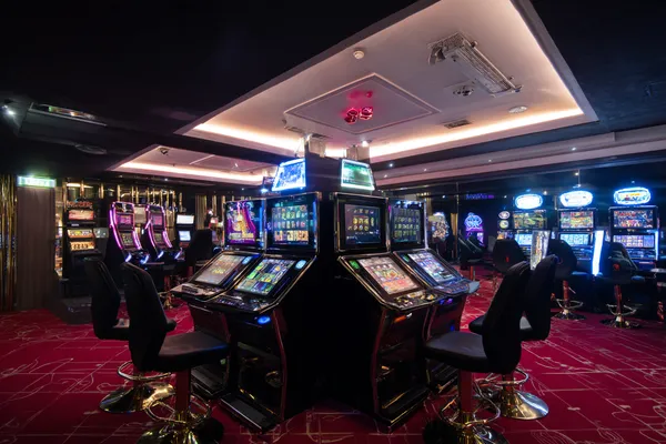 A person using their device against a moody casino-themed background, illustrating the smooth re-entry process at KRIKYY.
